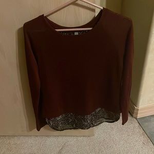 A gently used wine/burgundy long sleeved top with inverted V back